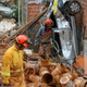 Firefighters remove mud in search of victims after a landslide caused by heavy rains buried homes in Franco da Rocha, Sao Paulo state, Brazil, on January 31, 2022. - Torrential rains in Brazil's Sao Paulo state between Friday and Sunday left at least 18 people dead, authorities said. (Photo by FILIPE ARAUJO / AFP)